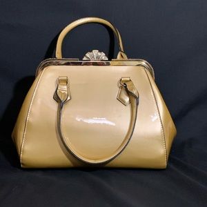 Gold purse with gold trim and rhinestone accents